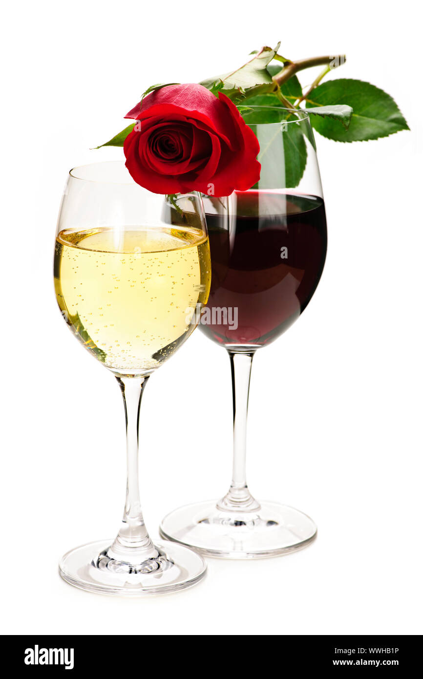 Romantic rose on top of red and white wine glasses isolated on white