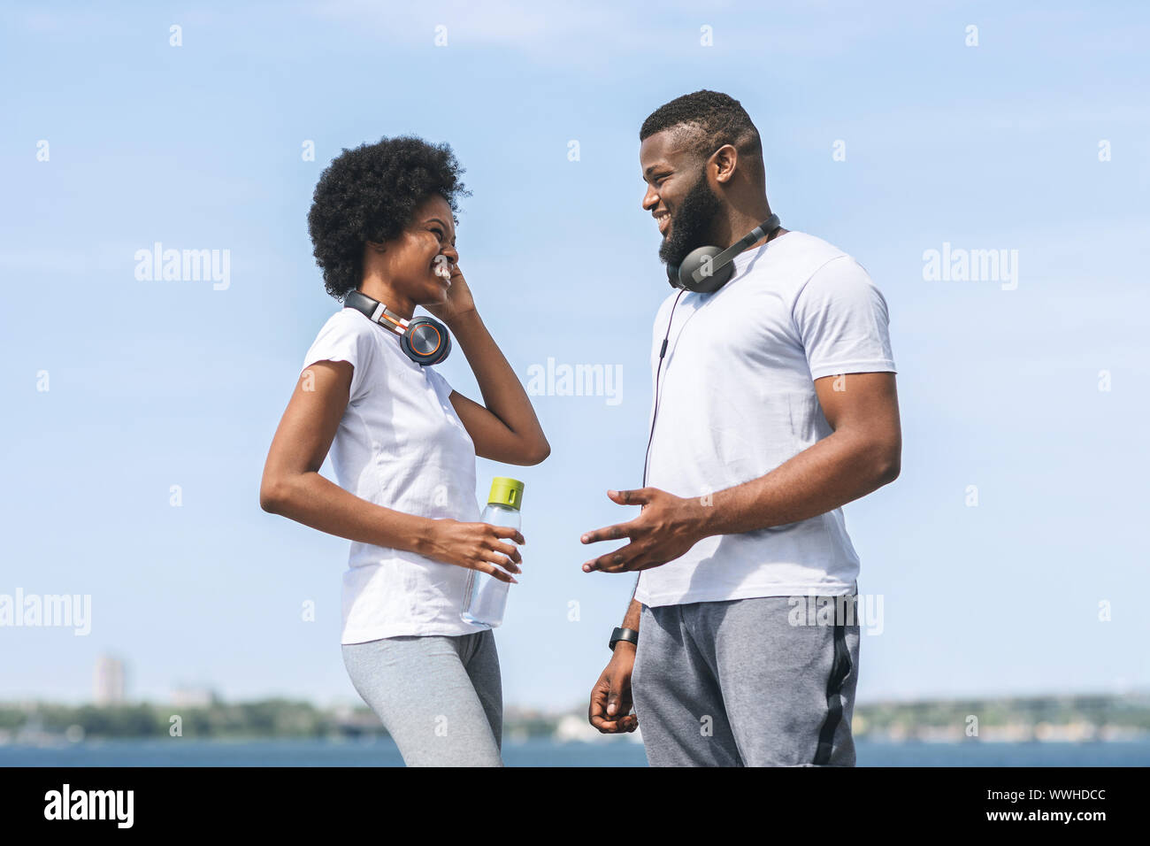 Man And Woman Talking After Morning Jog Near River Stock Photo