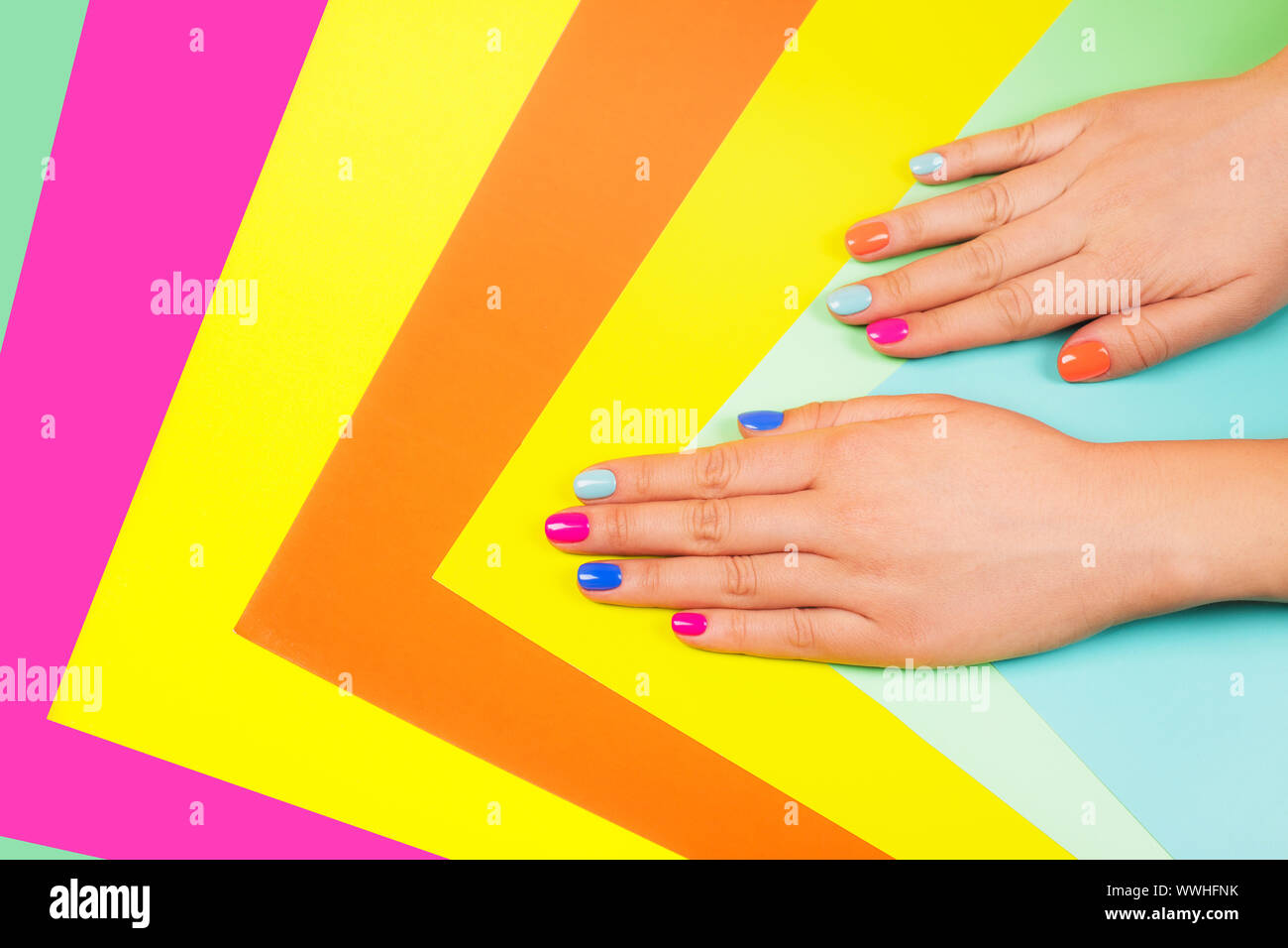 Neon manicure on multicolored bright background in trendy colors. Flat lay style. Stock Photo