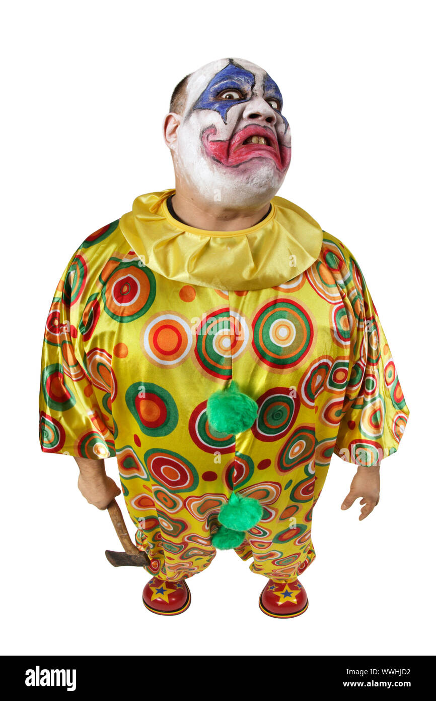 A nasty evil clown holding an axe, angry and looking mean. Fisheye lens with focus on the face. Stock Photo