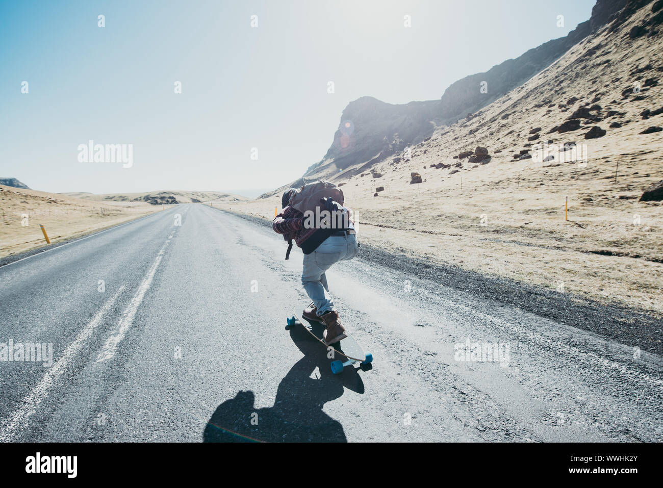 Skater traveling iceland on his longboard Stock Photo