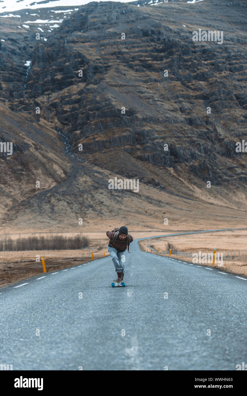 Skater traveling iceland on his longboard Stock Photo - Alamy