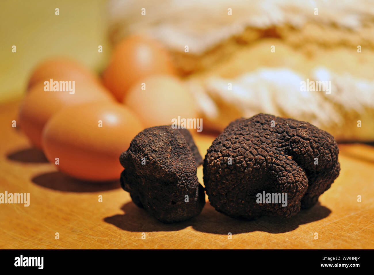 black truffles (tuber melanosporum) on a table with eggs and bred Stock Photo