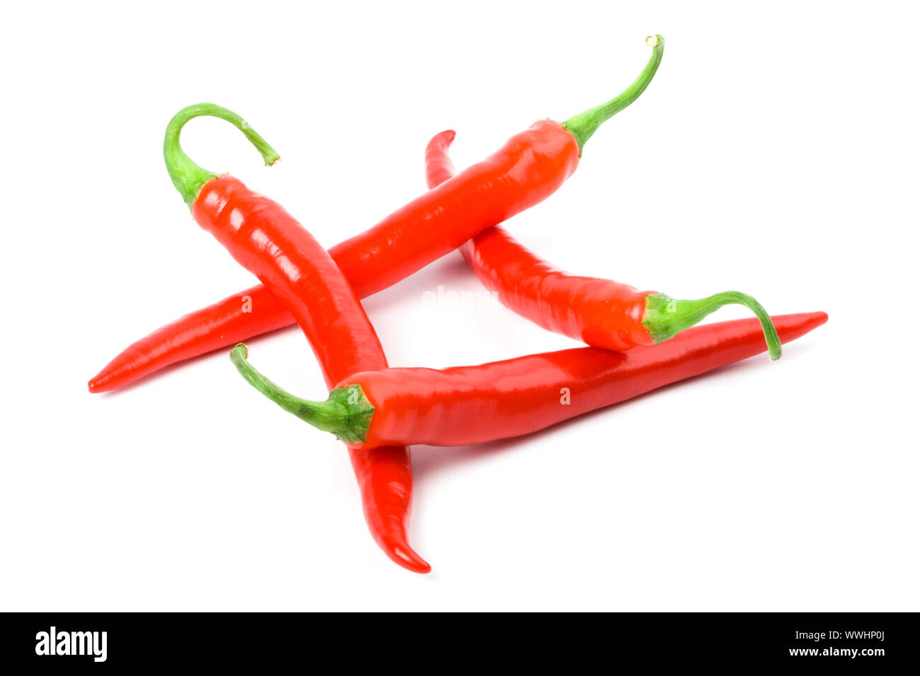 four red chilly peppers isolated on white background Stock Photo - Alamy