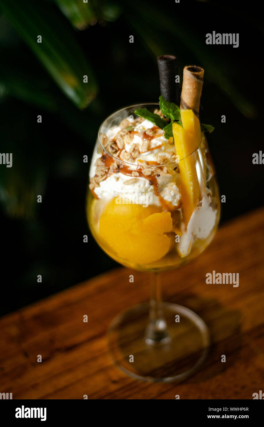 Organic Mango And Passion Fruit Tropical Ice Cream Sundae In Wine Glass Stock Photo Alamy