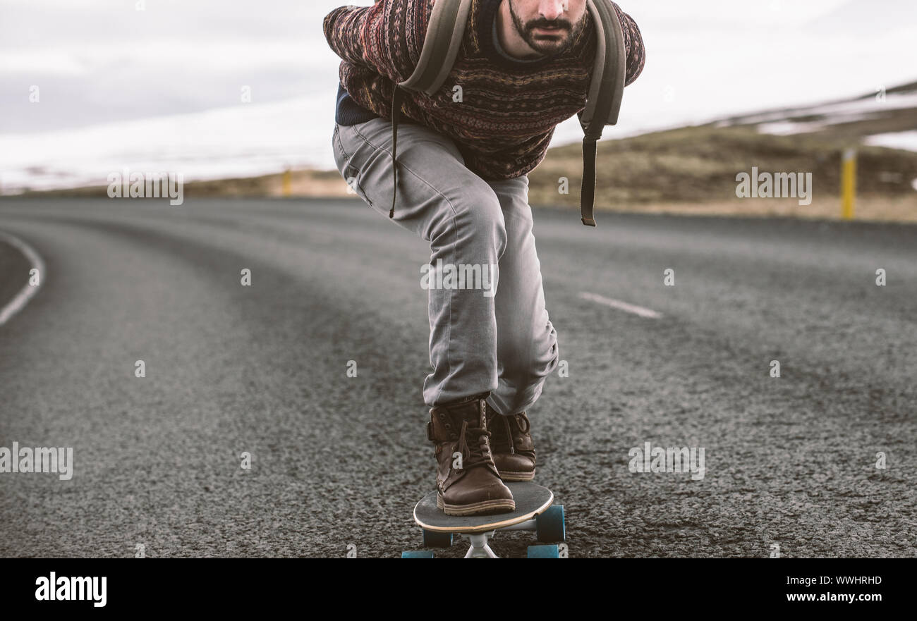 Skater traveling iceland on his longboard Stock Photo - Alamy
