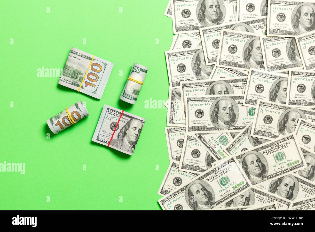 Heap of hundred Dollar Bills on colored background top view, with empty place for your text ...