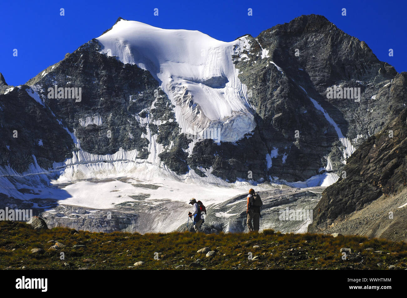 Hikers below the Mourti summits, Switzerland Stock Photo