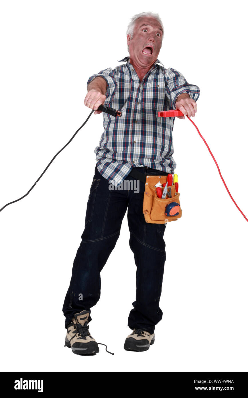Man getting an electric shock from jump leads Stock Photo Alamy