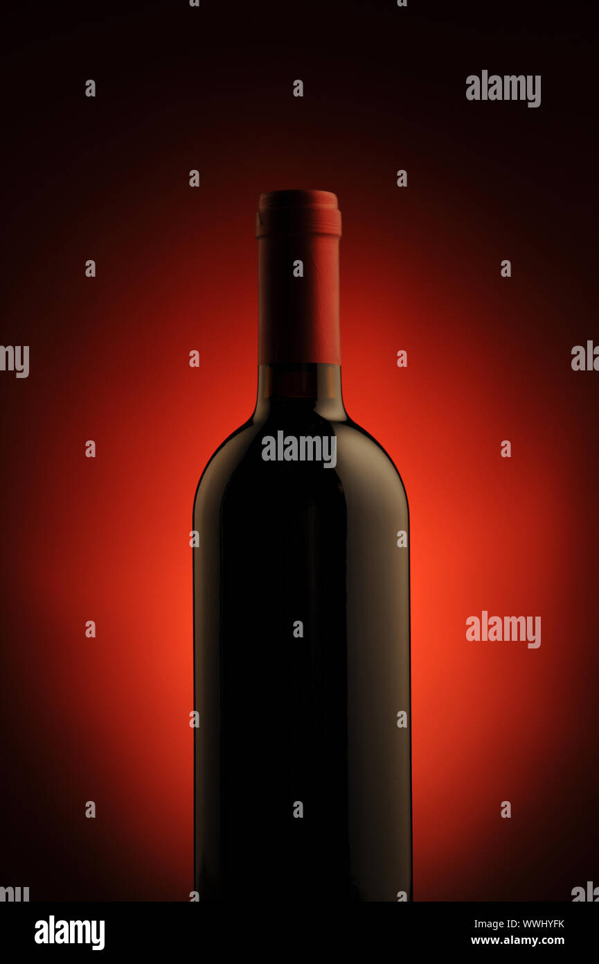 red wine bottle , red light on background Stock Photo Alamy