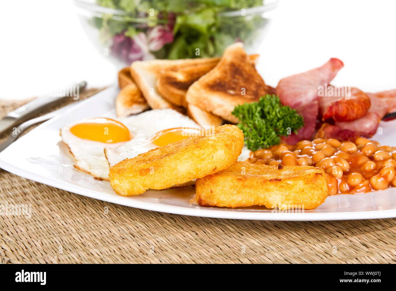 Breakfast with eggs bacon beans and hash browns Stock Photo - Alamy