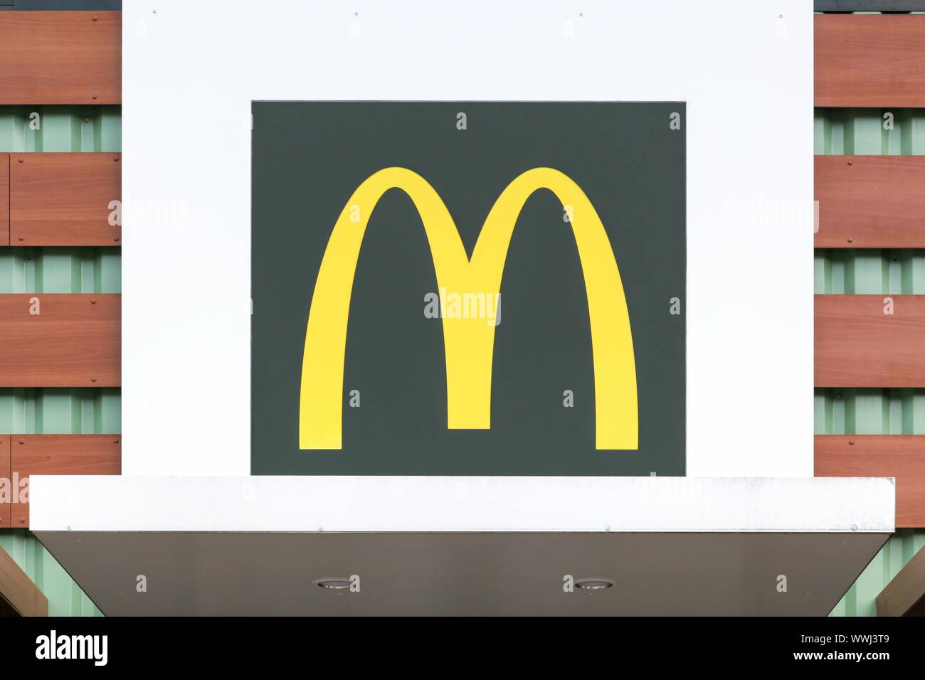 Voiron, France - June 1, 2018: Mc Donald's logo on a facade. McDonald's is the world's largest chain of hamburger fast food restaurants Stock Photo