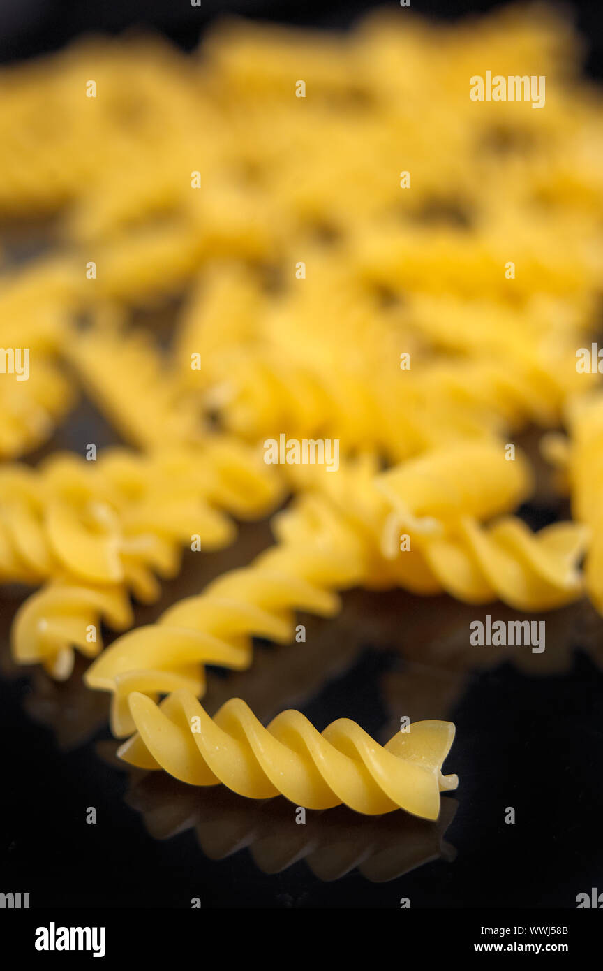 Italian pasta spiral fusilli over black closeup DOF Stock Photo Alamy