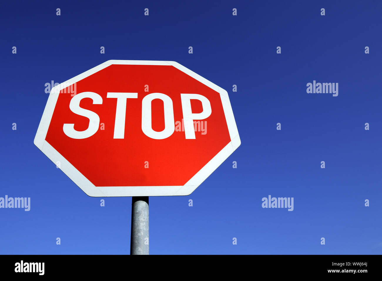 Stop sign in front of blue sky Stock Photo