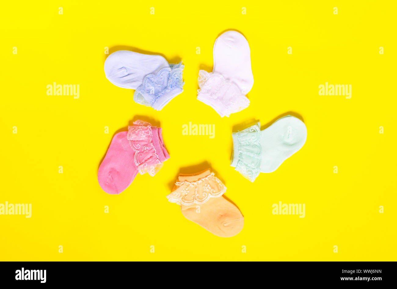 Baby socks hanging on clothes line hires stock photography and images