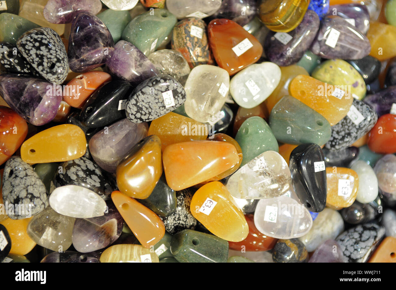 various semi-precious stones cut and processed to chain pendants Stock Photo