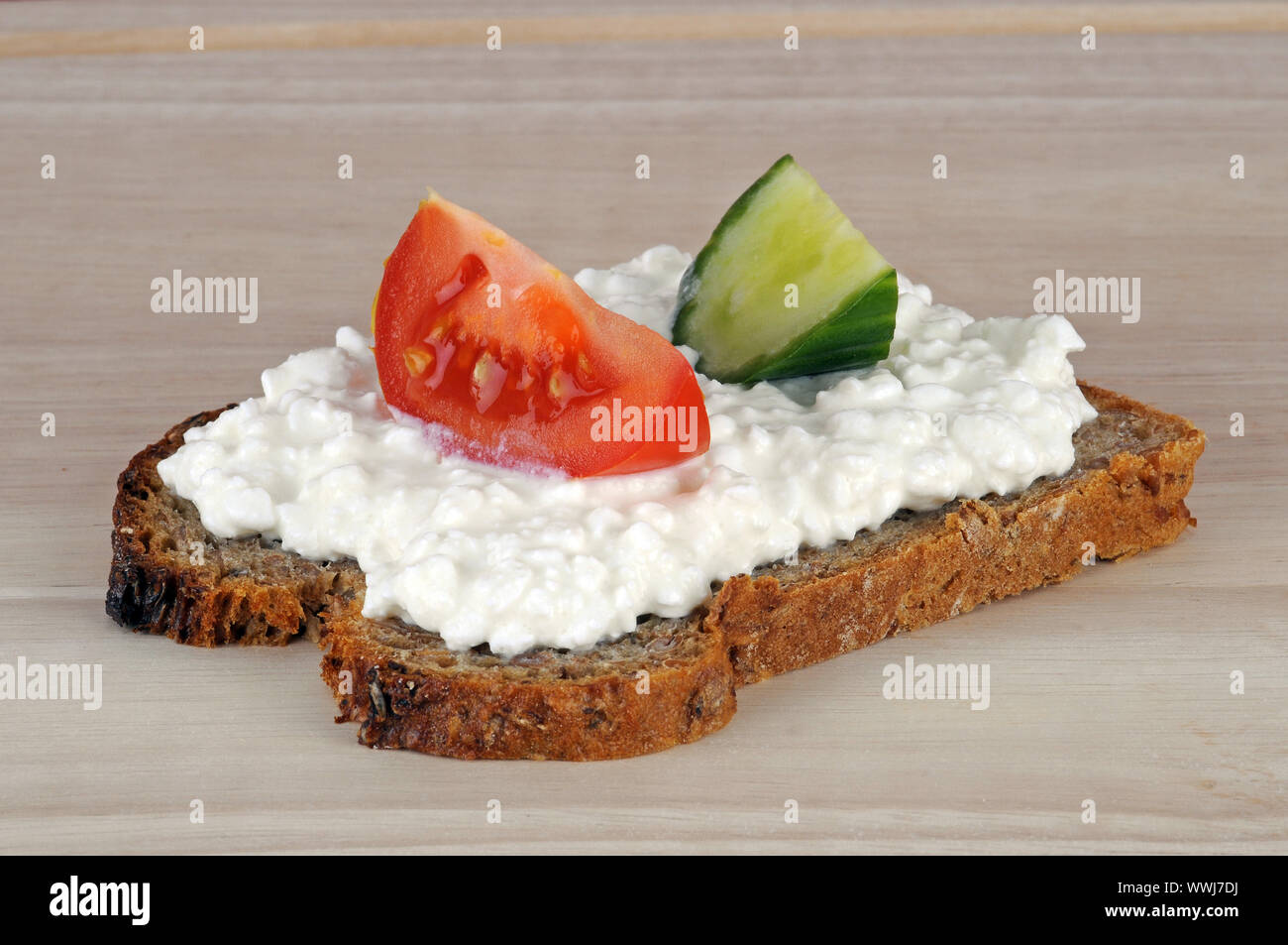 Wholemeal bread with fresh cheese, cottage cheese, tomato, cucumber Stock Photo