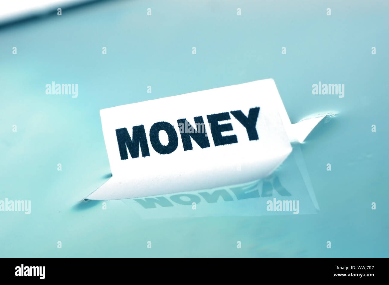 Card floating on water surface with printed word: MONEY Stock Photo