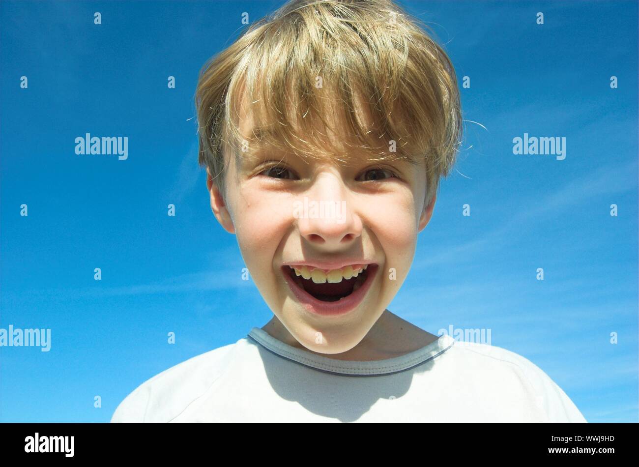 Happy boy on sky background Stock Photo - Alamy