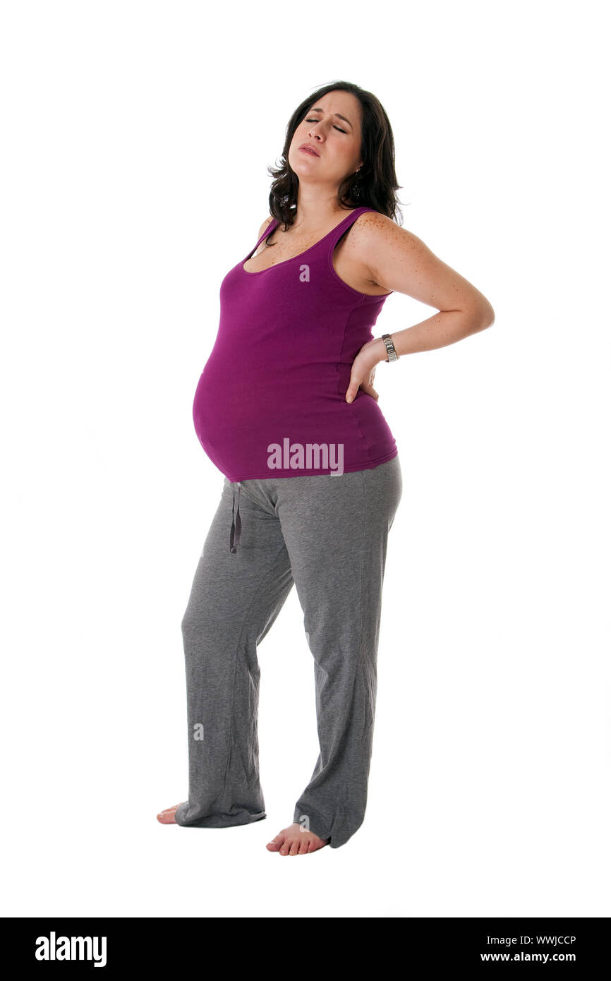 Beautiful pregnant Caucasian woman holding her back with an
