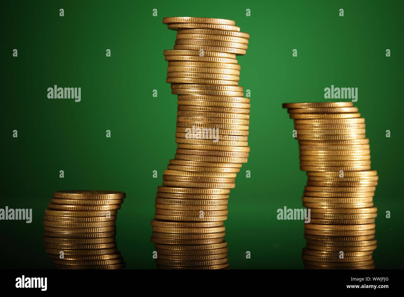 golden coins on green background Stock Photo - Alamy
