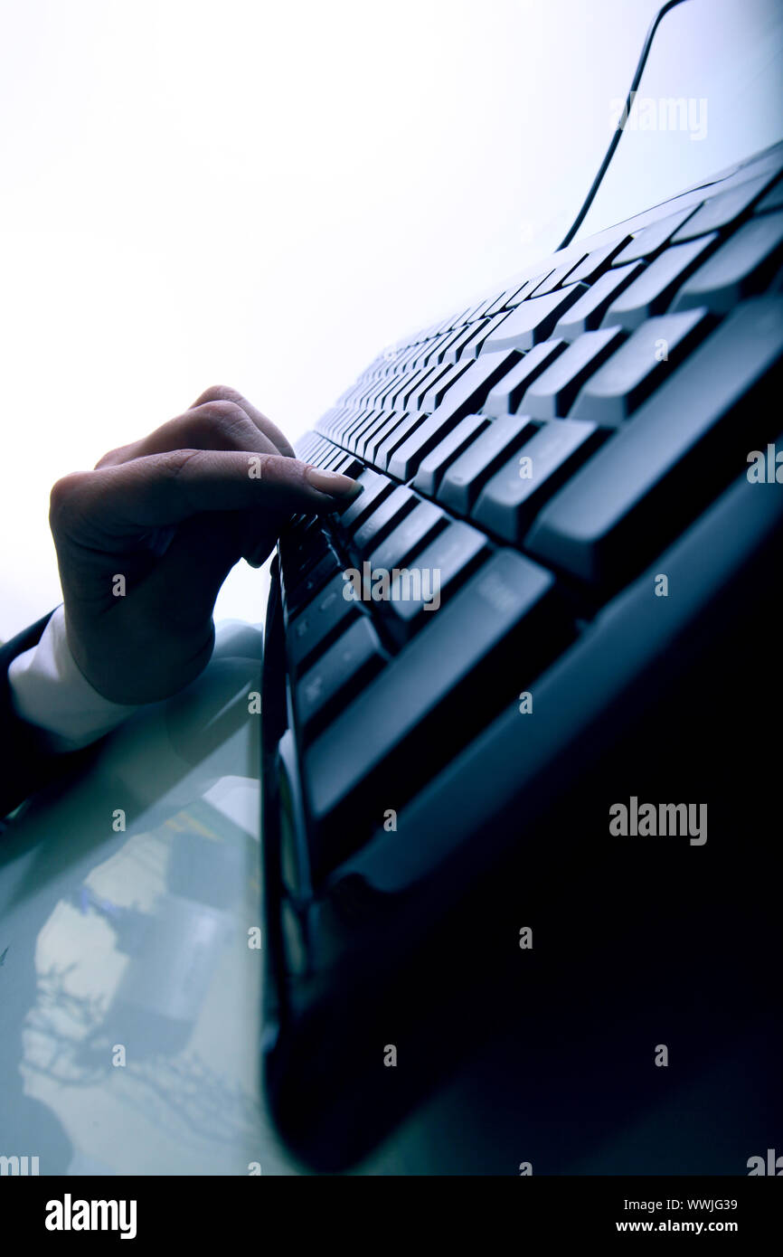 hand press a key on keyboard Stock Photo Alamy