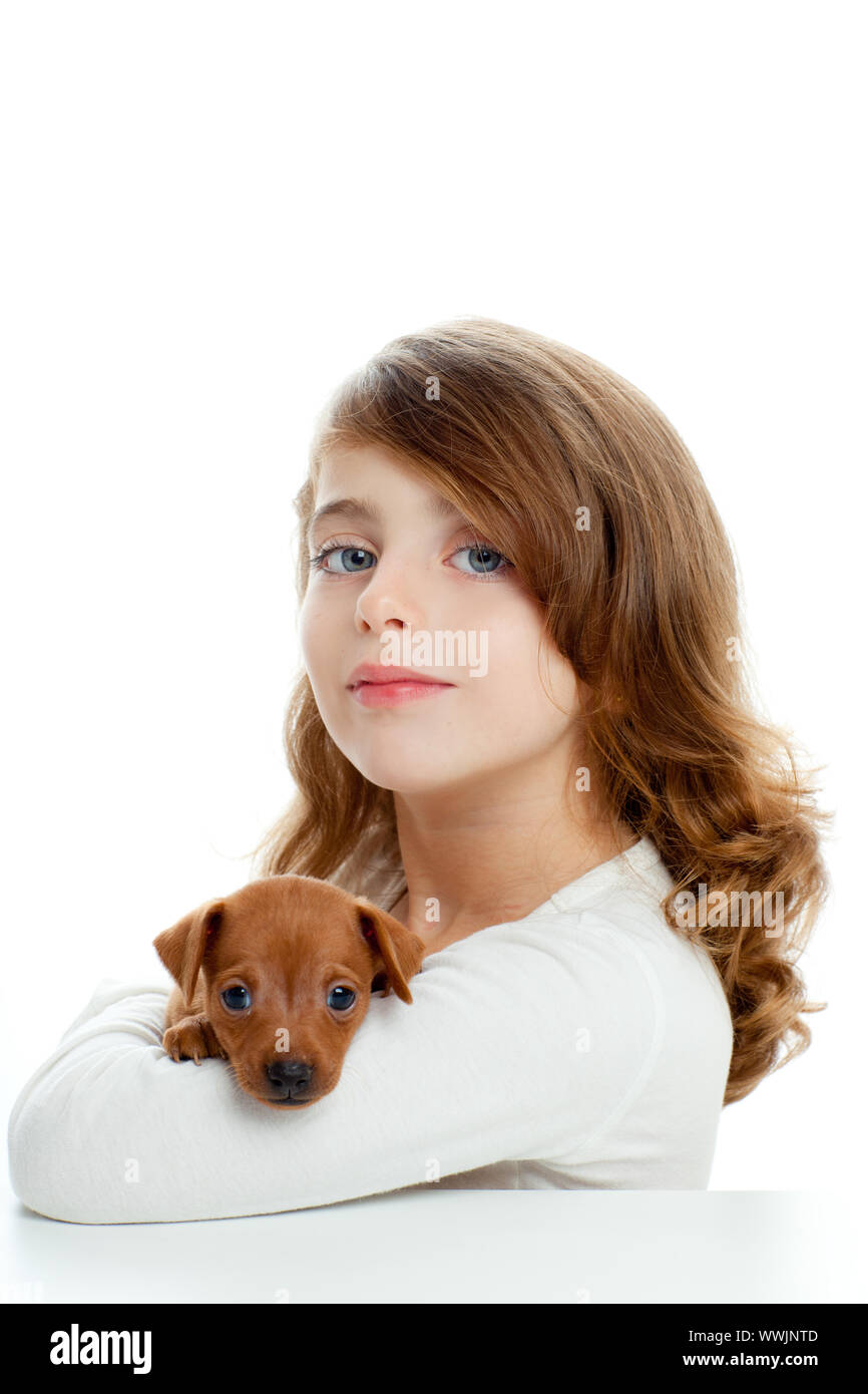 Brunette kid girl with puppy dog mascot mini pinscher on white ...