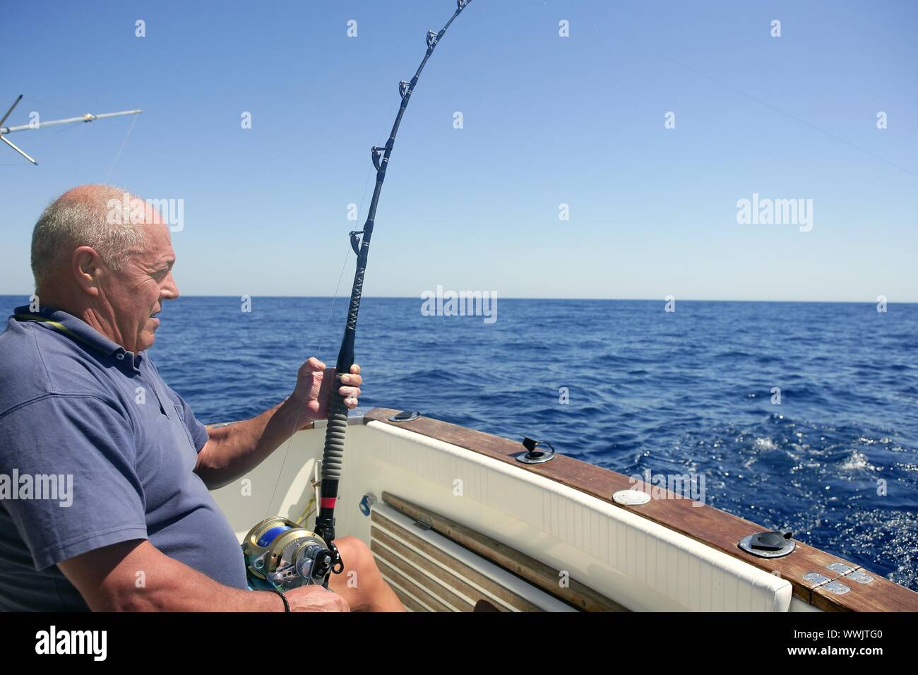 Angler elderly big game sport fishing boat blue summer sea sky Stock Photo - Alamy