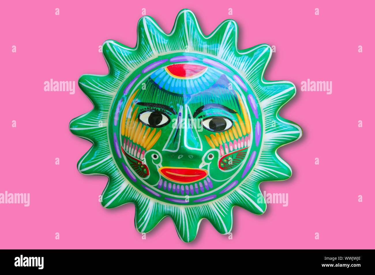 Mexican indian sun handcraft ceramic isolated in pink background Stock Photo