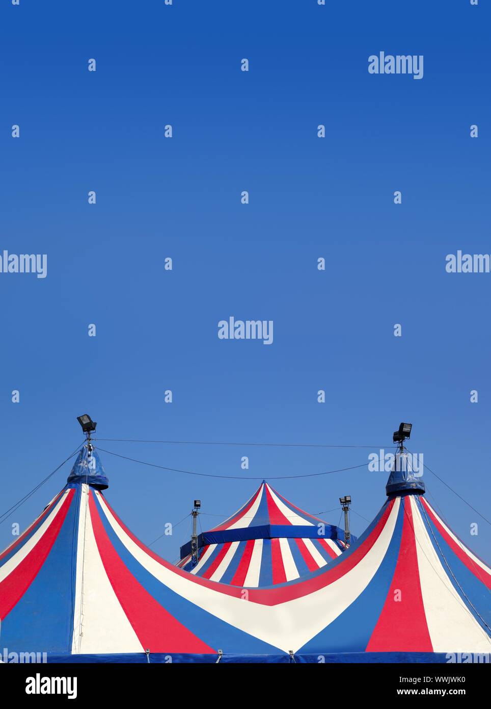 Circus tent under blue sky colorful stripes red white Stock Photo - Alamy