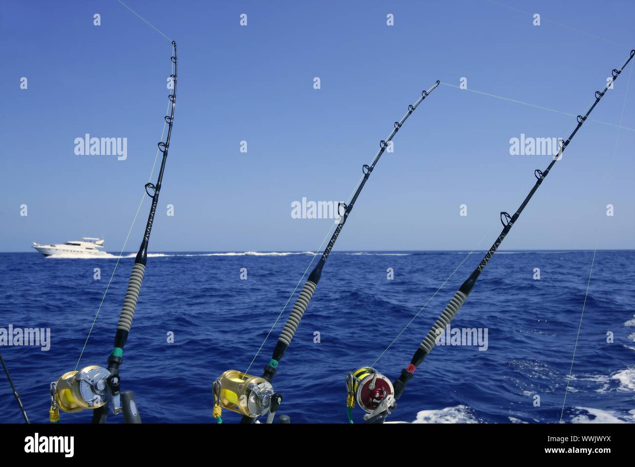Blue sea and sky in a big game tuna fishing day rods and reels on boat