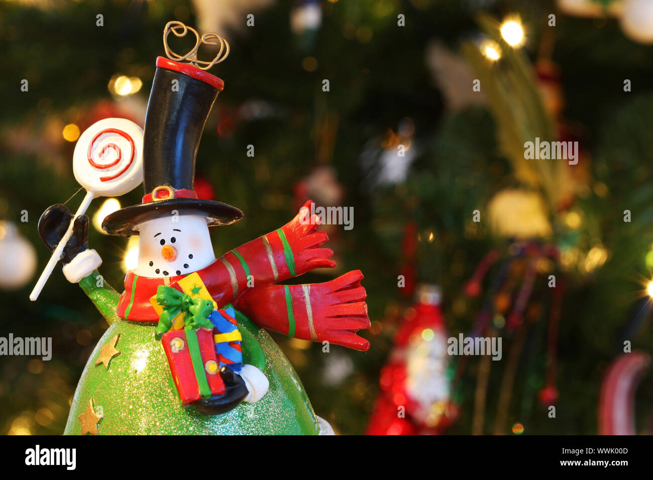 A christmas decoration in the form of a snowman, waving and holding ...