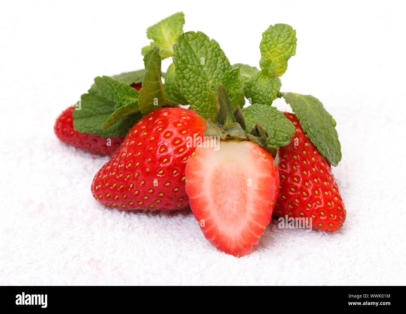 Strawberries with mint over white background Stock Photo - Alamy