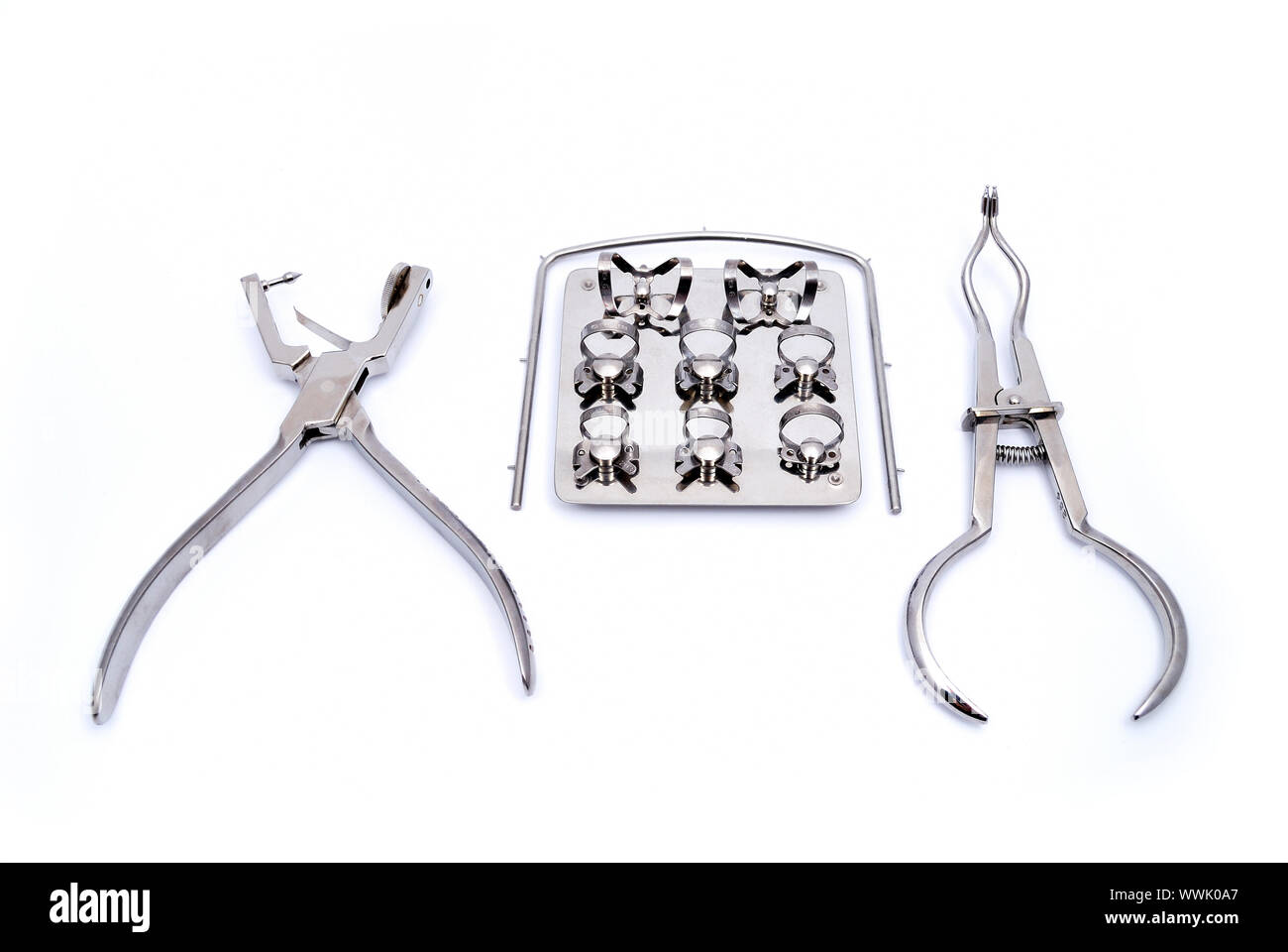 Dental kit rubber dam frame, punch, forceps Stock Photo Alamy