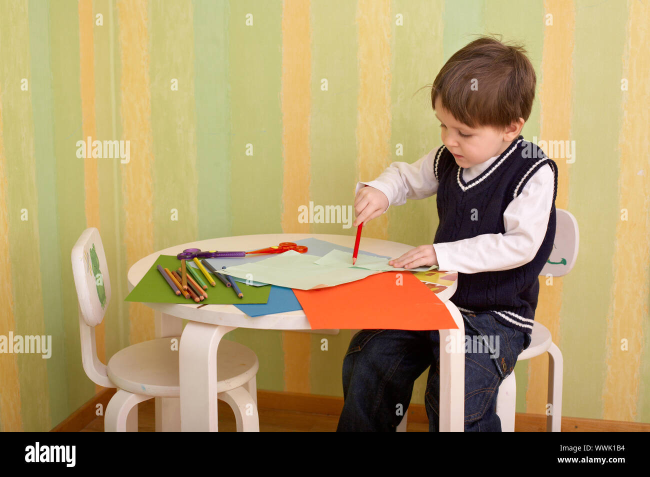 Creativity moment. Small boy creating piece of art with pencils, color ...