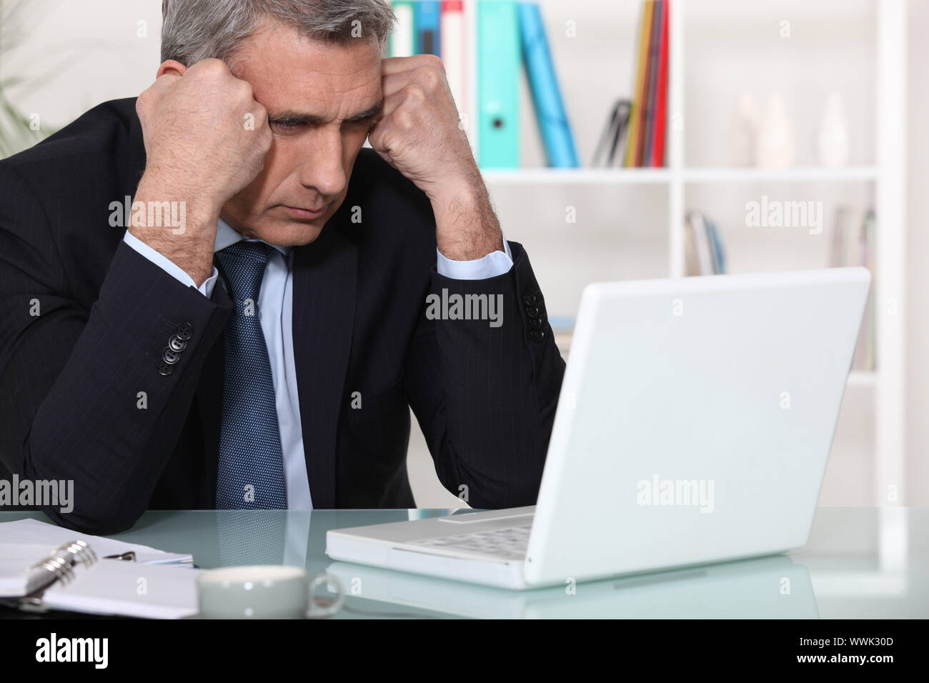 Businessman concentrating on his laptop Stock Photo - Alamy