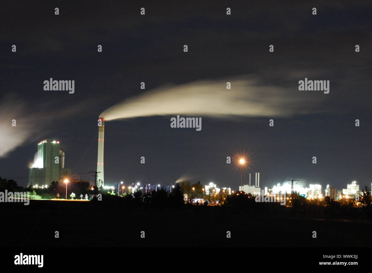 a smoking industrial power plant at night Stock Photo - Alamy