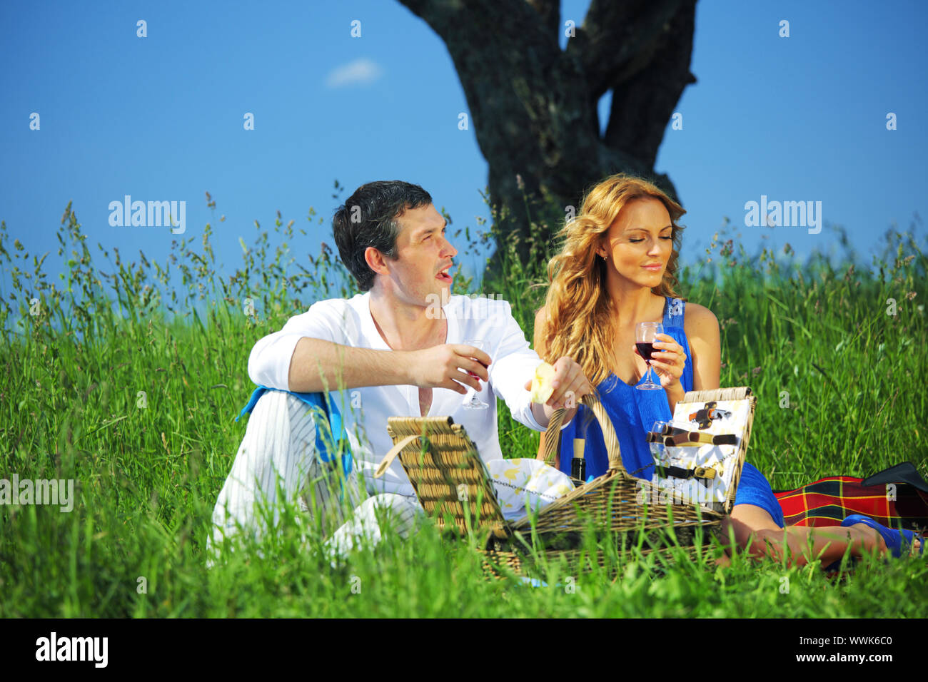man and woman on picnic in green grass Stock Photo - Alamy