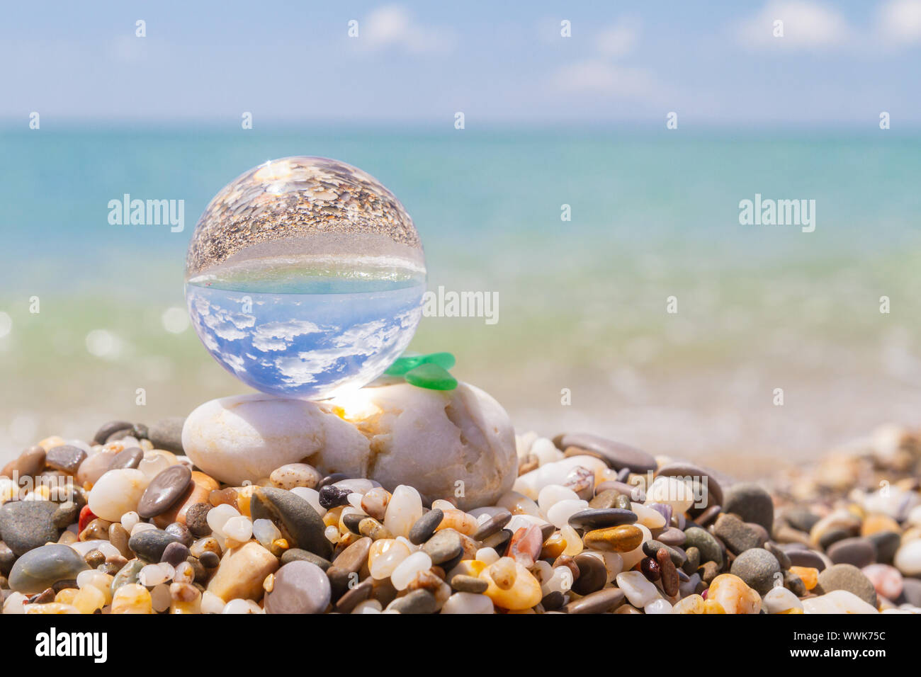 Glass round ball on the beach reflects the sea in summer Stock Photo ...