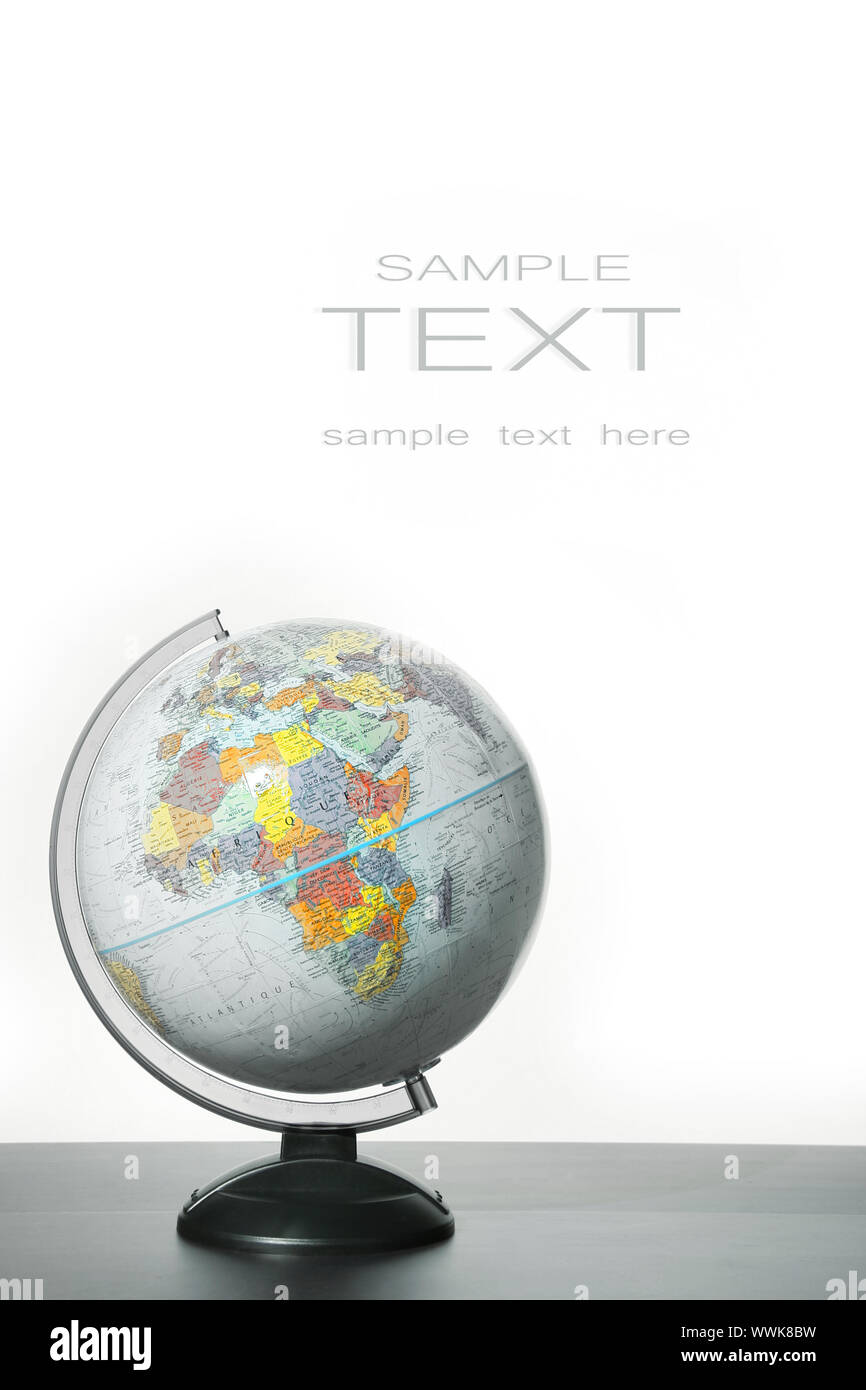 Globe with stand on desk against white background Stock Photo - Alamy