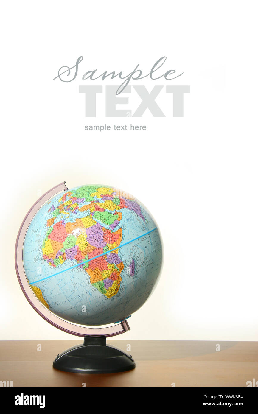 Globe with stand on desk against white background Stock Photo - Alamy