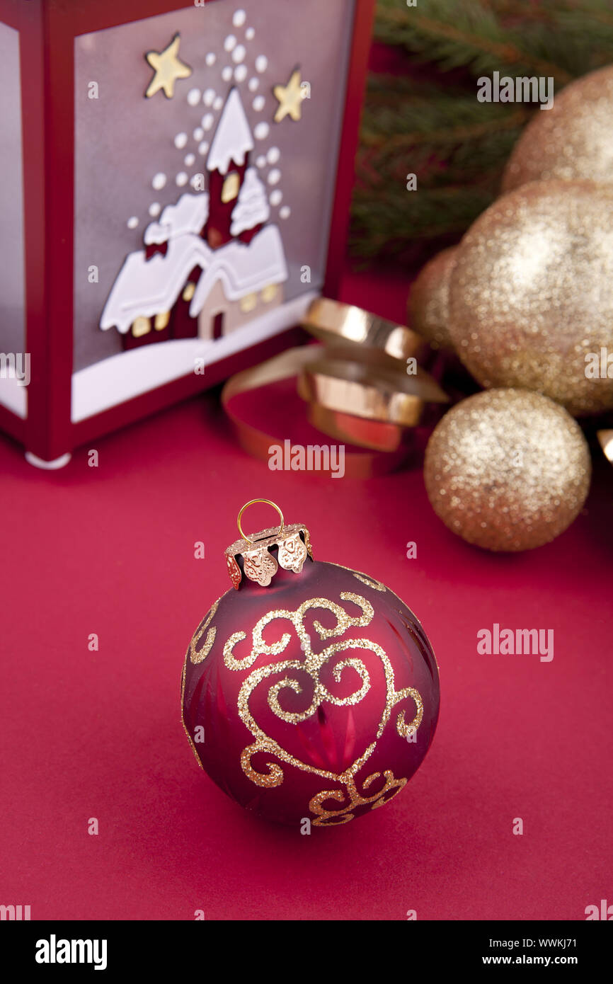 Christmas decoration with baubles, lamp and fir tree on red background Stock Photo