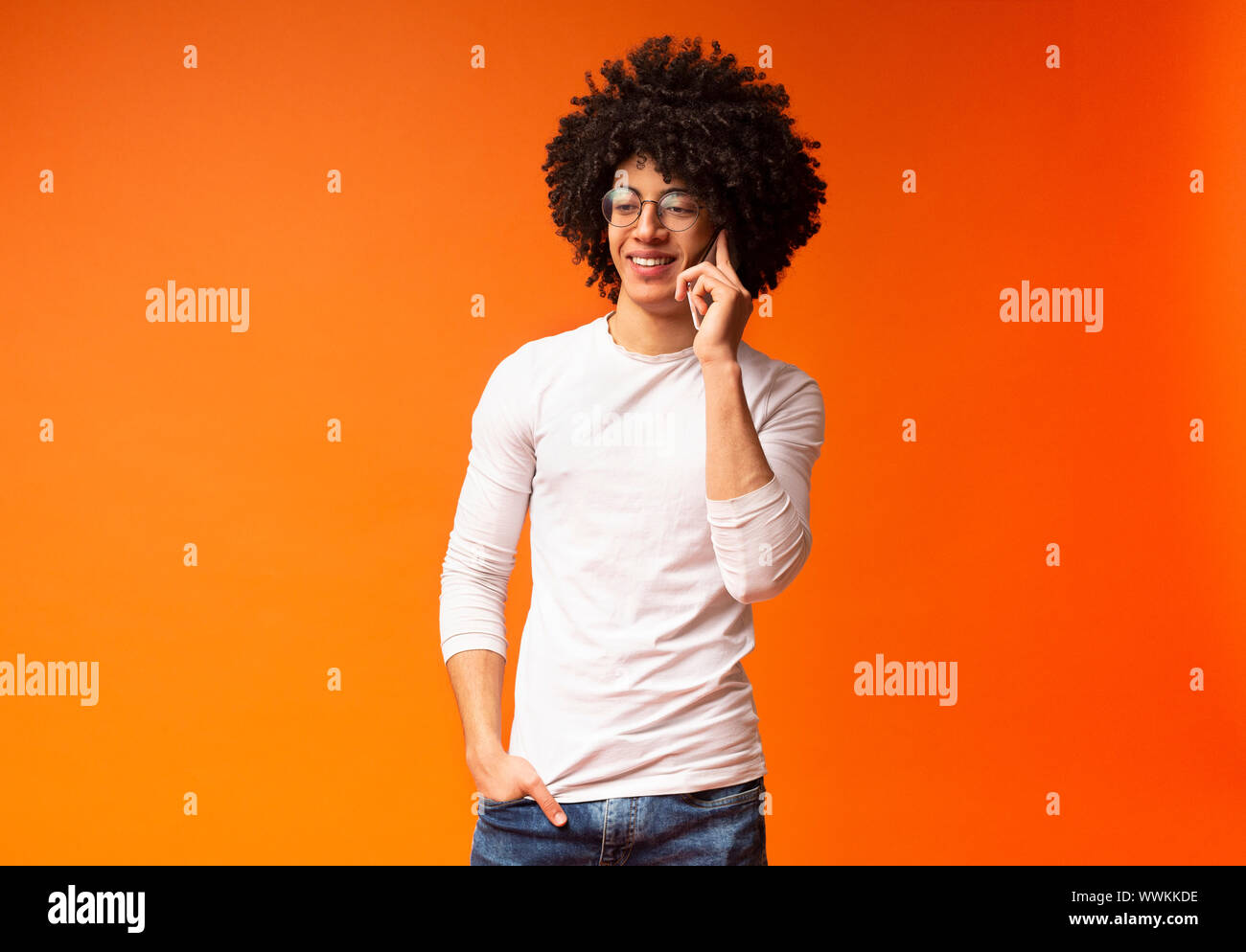Modern Relaxed Black Guy Talking On Cellphone Stock Photo