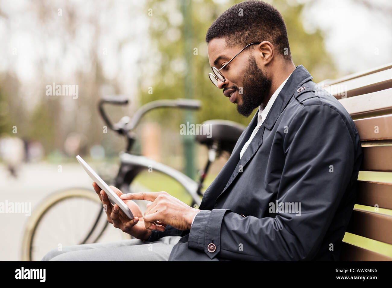 Young freelancer using digital tablet in park Stock Photo