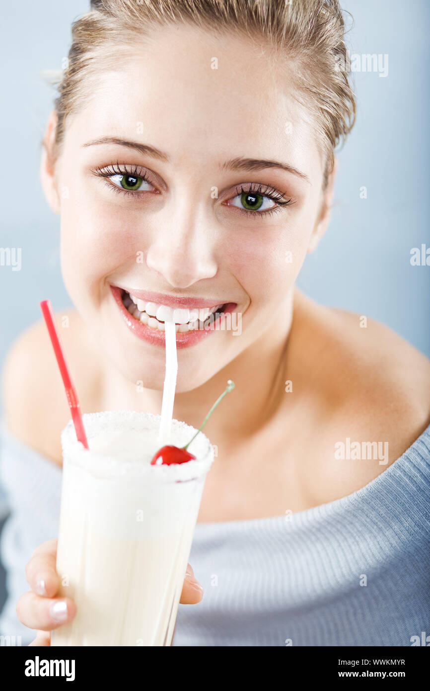 Beautiful woman drinking milk cocktail Stock Photo Alamy