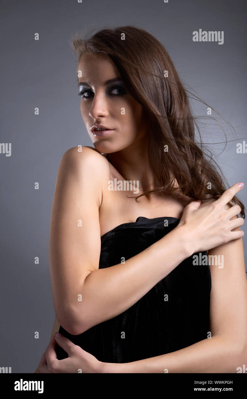 attractive young model covers her chest with black cloth Stock Photo