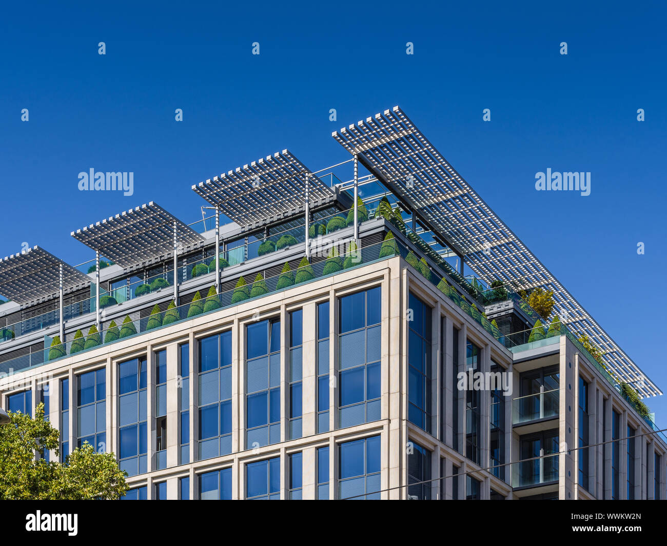 Roof garden with clipped bushes, and sun-screens on modern building - Vienna, Austria. Stock Photo
