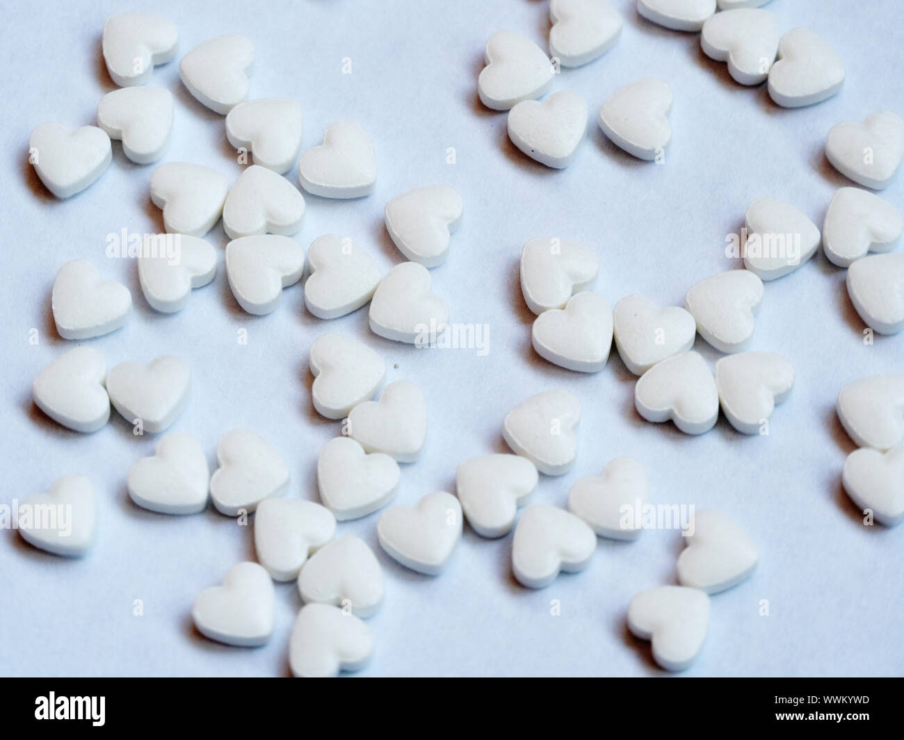 A lot of pills in the heart shape on white background Stock Photo