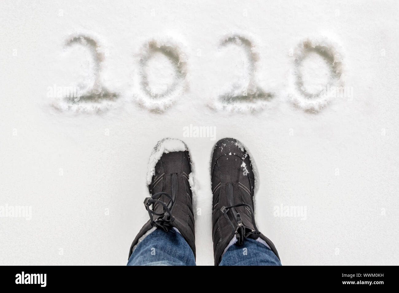 2020 written in the snow with selfie of boots, winter new year greeting card Stock Photo