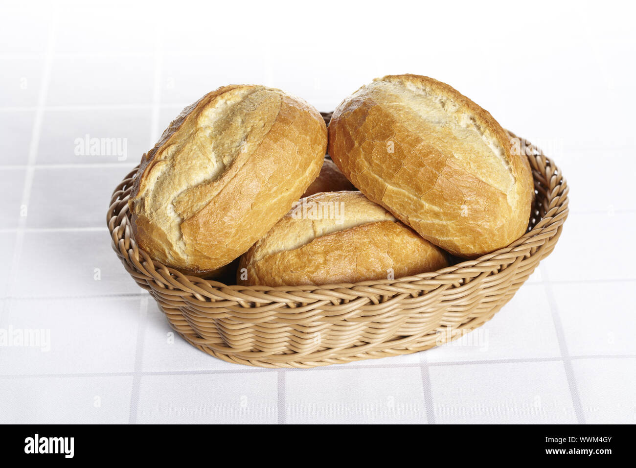 Basket with bread rolls on dams tablecloth Stock Photo